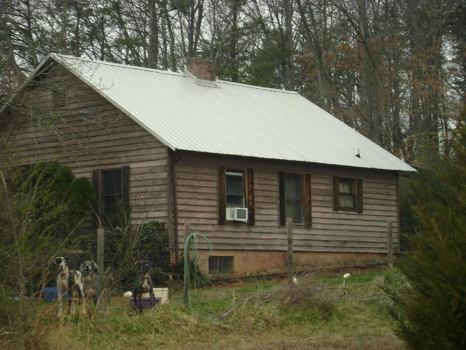 White metal roof on an old wood sided farmhouse, from a Metal Roof Installation job in Lanexa